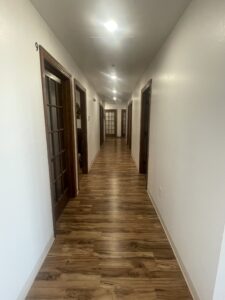 Clean, well-lit hallway leading to therapy rooms at Spruce Canyon Wellness